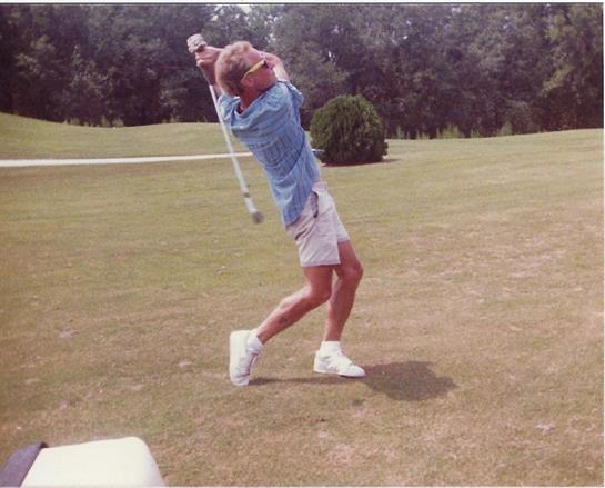 Man enjoys a round of golf, focusing intently on his swing in a scenic location.