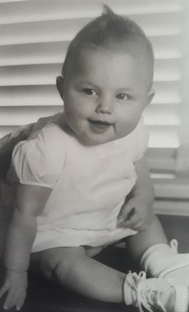A baby sitting on a floor