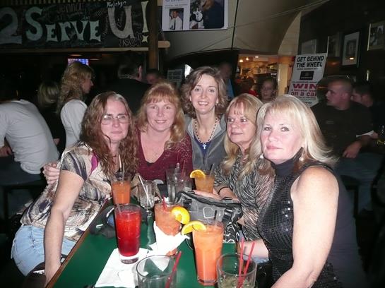 A group of women sitting at a table with drinks