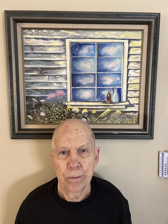 A man standing in front of a painting
