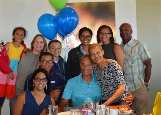 A vibrant group of family members enjoying a joyful celebration together at a restaurant.