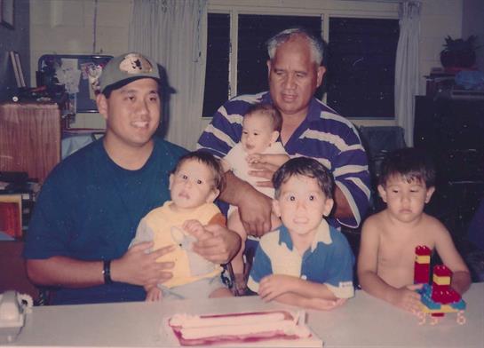 Family members celebrate with children at a birthday gathering, sharing joy and laughter.