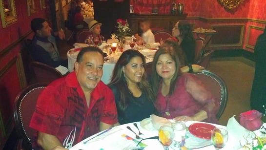 Friends and family gather for a joyful dinner amid festive decor and lively talk.