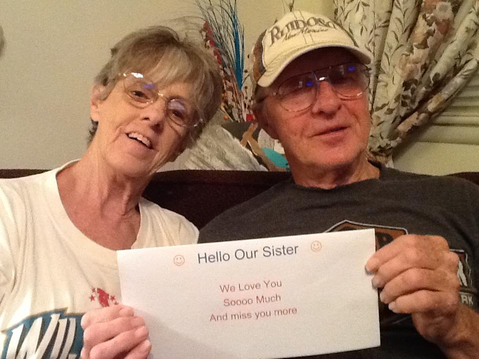 A man and woman holding a piece of paper