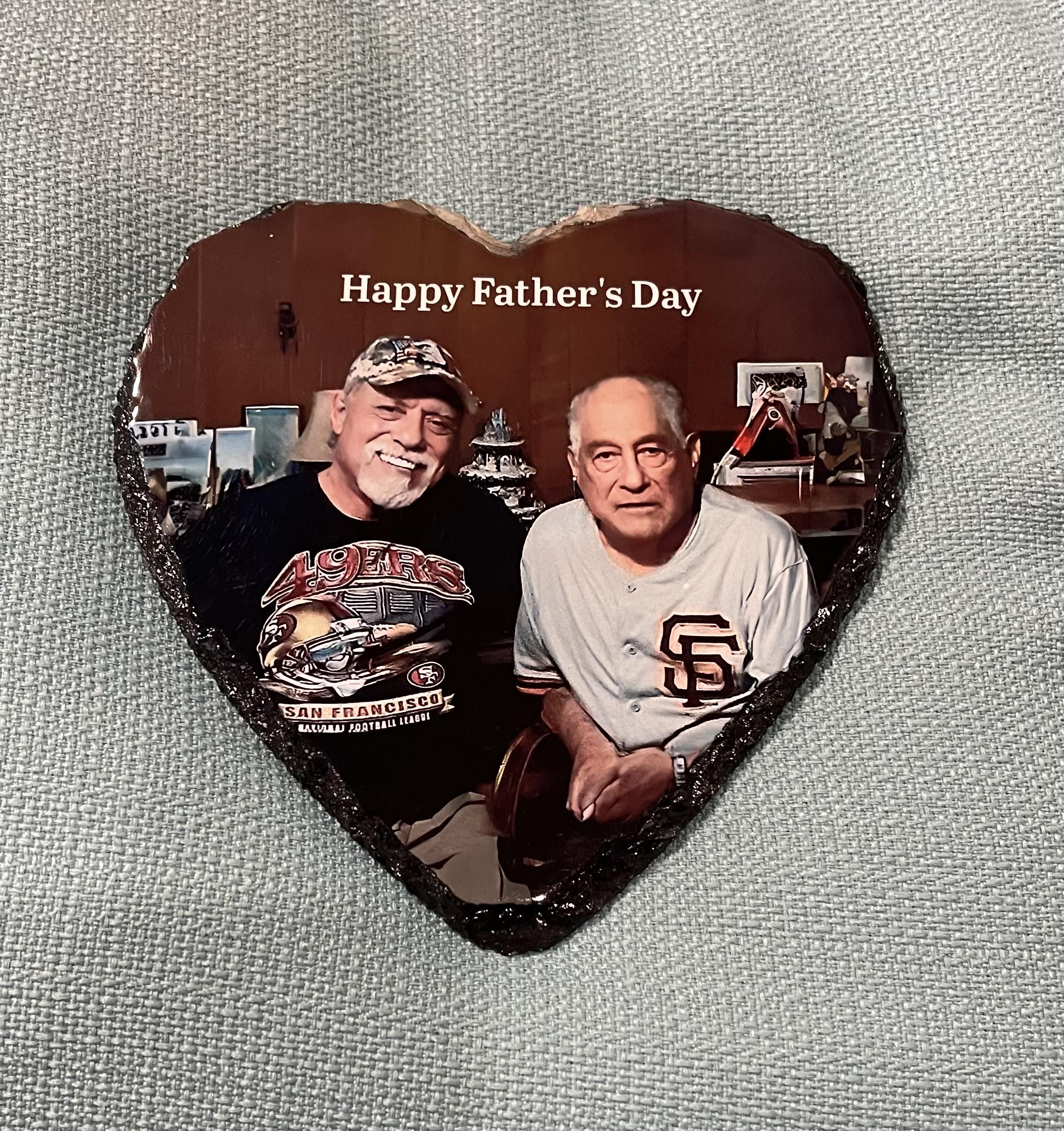 Two men pose for a heartfelt keepsake, celebrating Father's Day together with smiles.