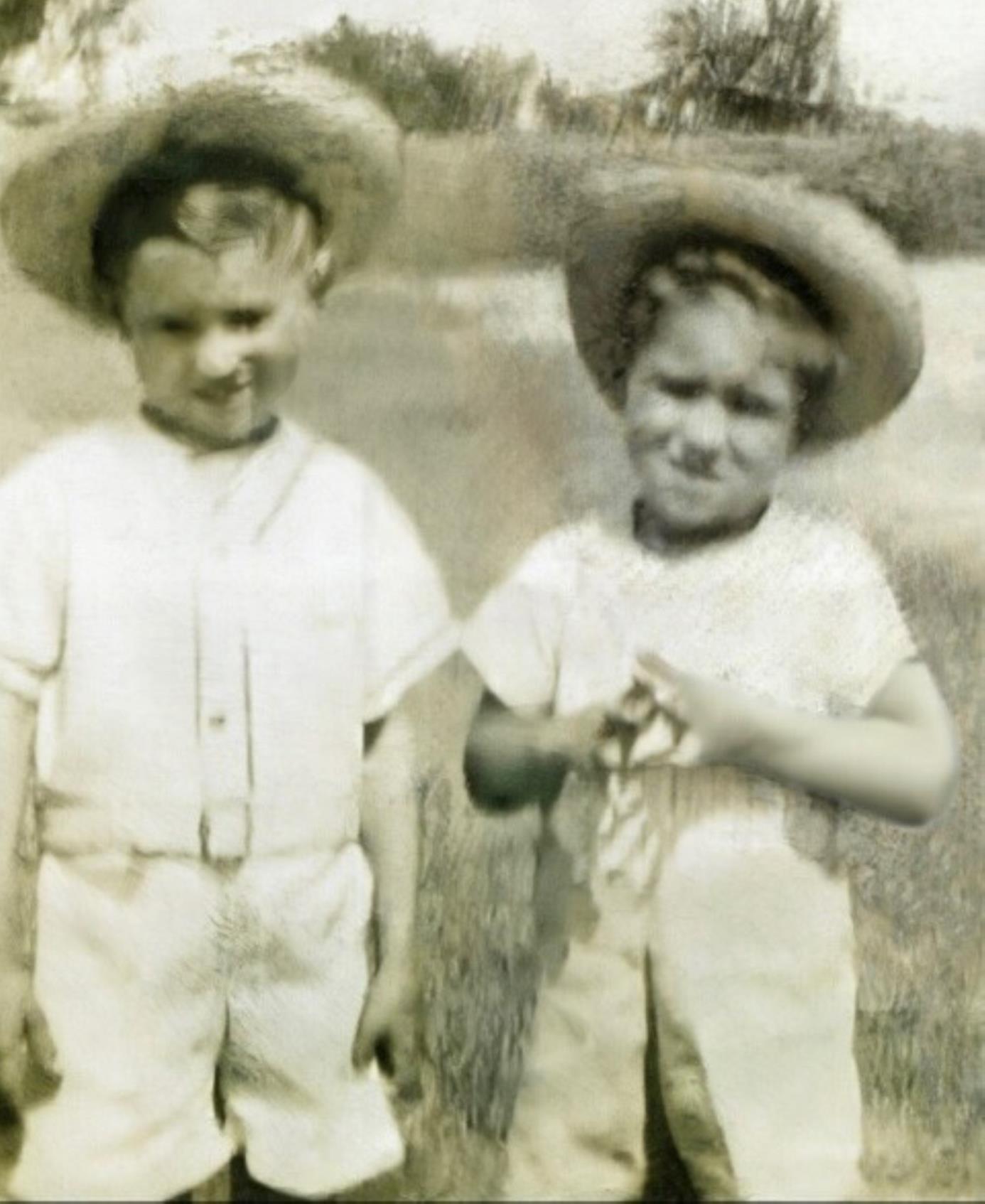 A couple of young boys wearing hats