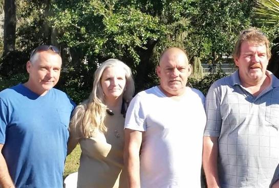 A group of people standing together outside