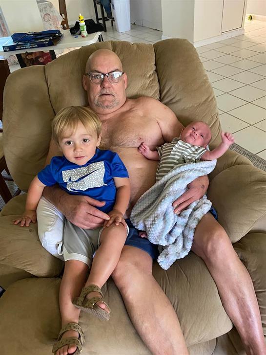 A man holding two babies