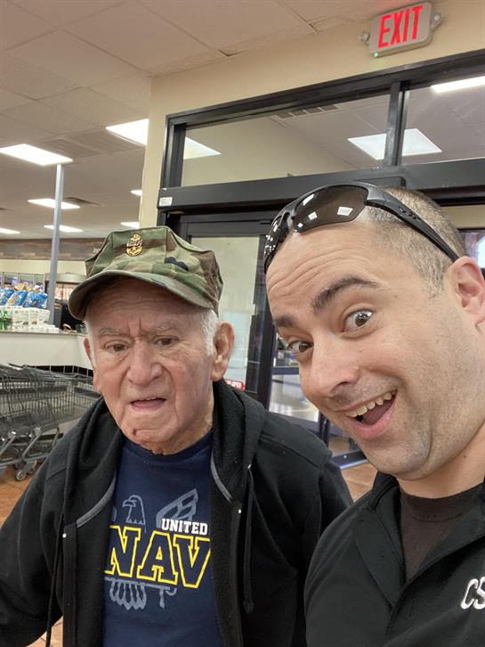 Senior man and younger man share a lighthearted moment while shopping at a retail store.