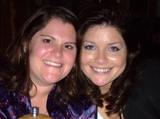 Two women enjoy each other's company while smiling warmly at a friendly gathering.