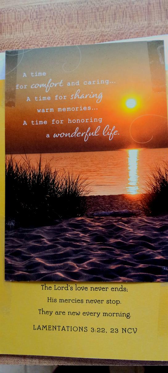 A stunning sunset lights up the lake, as gentle waves create a serene atmosphere.