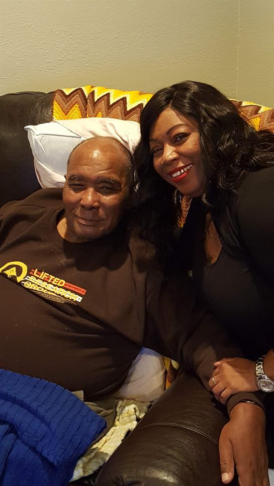 A man and woman smile together on a couch, enjoying a friendly and intimate moment at home.