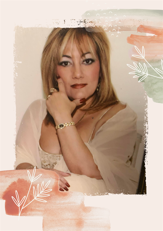 A confident woman in a light outfit poses with an elegant look, showcasing her style and charm.