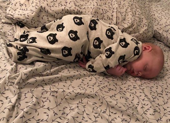 A baby lying on a blanket