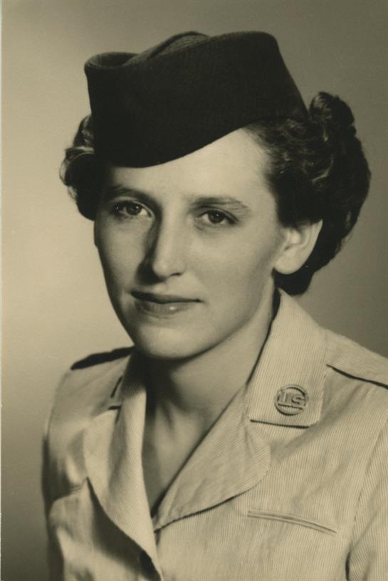 A woman in military uniform poses for a formal portrait, showcasing her dedication and pride.