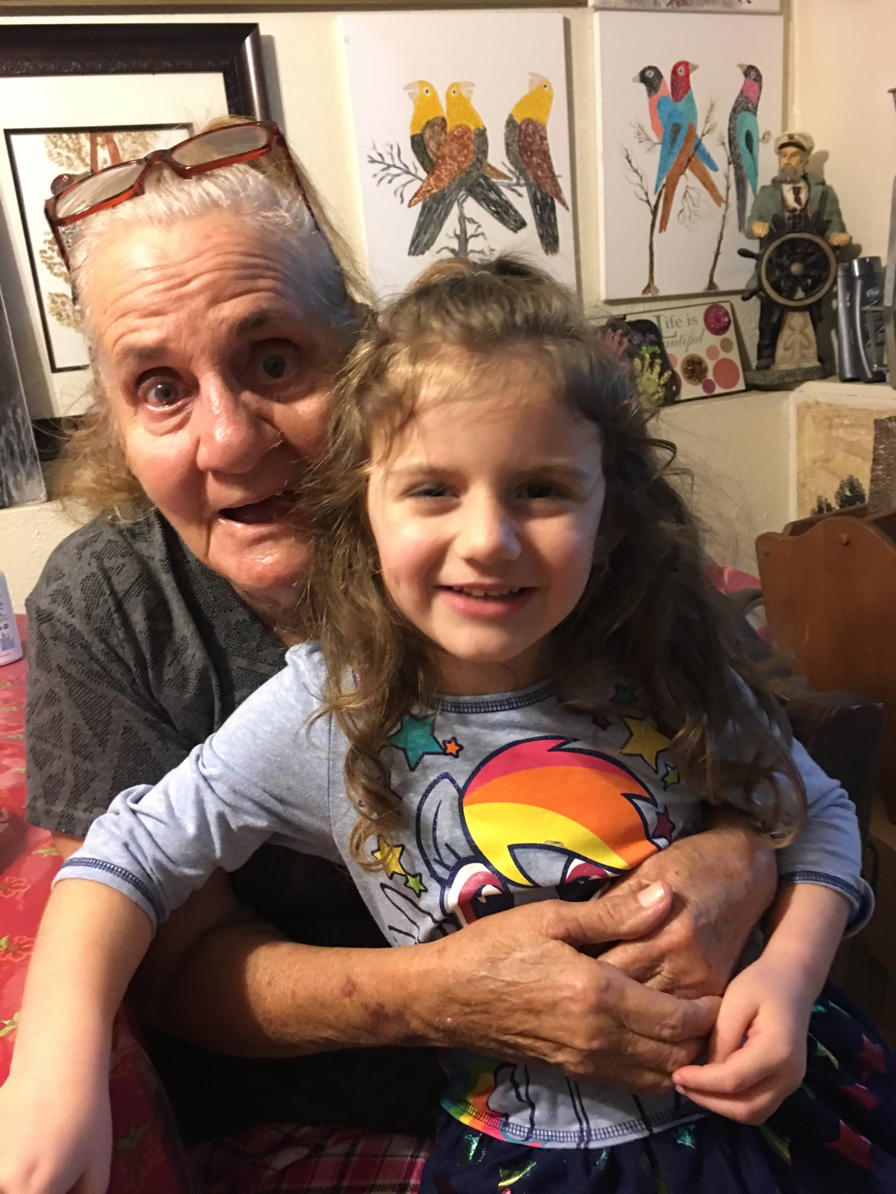An older woman and a young girl posing for a picture