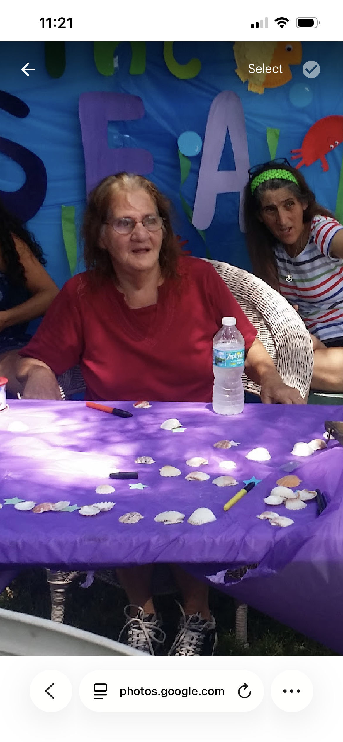 A woman sitting at a table with seashells on it