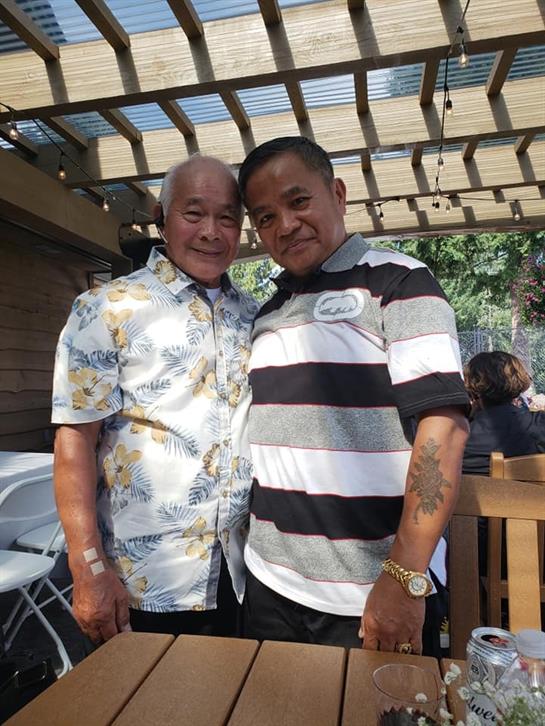 Two men standing next to each other
