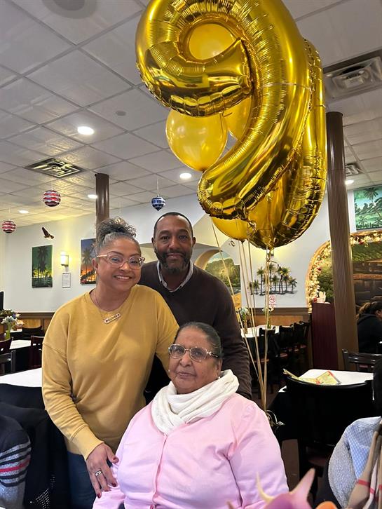 Friends and family gather in a restaurant to celebrate a special birthday with joy.