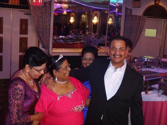 Guests enjoy a lively family gathering, sharing smiles and hugs in a festive atmosphere.