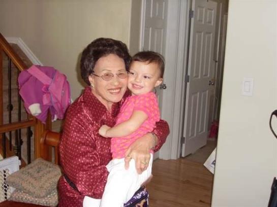 Grandmother joyfully embraces her smiling granddaughter in a warm, inviting home atmosphere.
