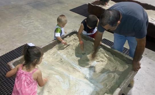 A group of kids playing in sand