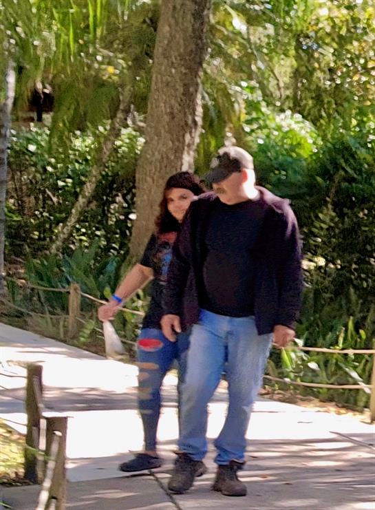 A man and woman walking on a path