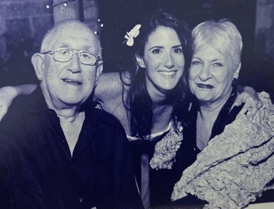 Friends enjoying a lively gathering, sharing smiles and laughter under bright decorations.