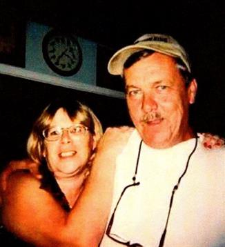 Two friends share a joyful moment at a social gathering, posing for a close-up while smiling.