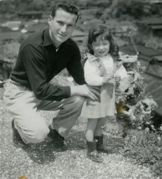A man and a little girl posing for a picture