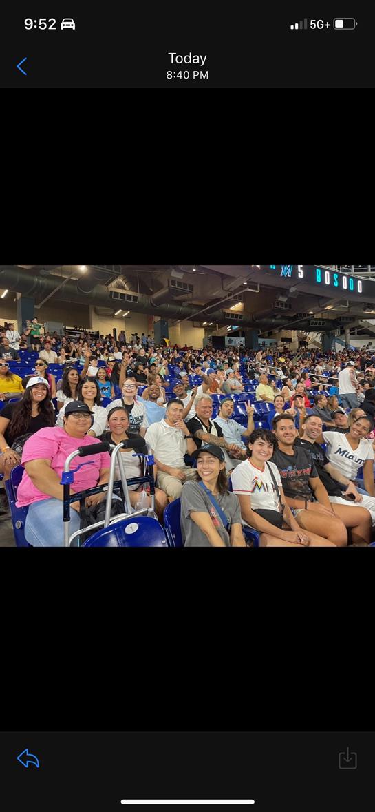 Fans gather in a vibrant indoor arena, cheering and celebrating during an exciting sports event.