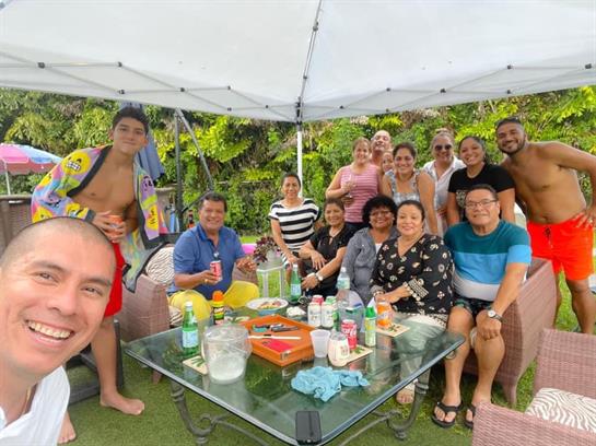 A lively group of friends celebrating together at a summer gathering by the pool.