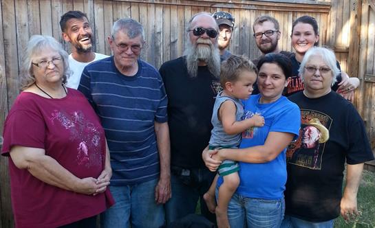 A joyful family gathers in a backyard, enjoying time together with a mix of ages and personalities.