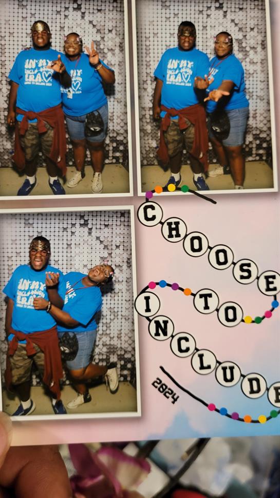 Two friends strike playful poses at a photo booth with a vibrant backdrop in 2024.