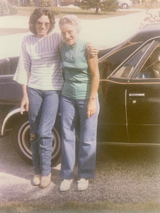 A woman standing next to a woman