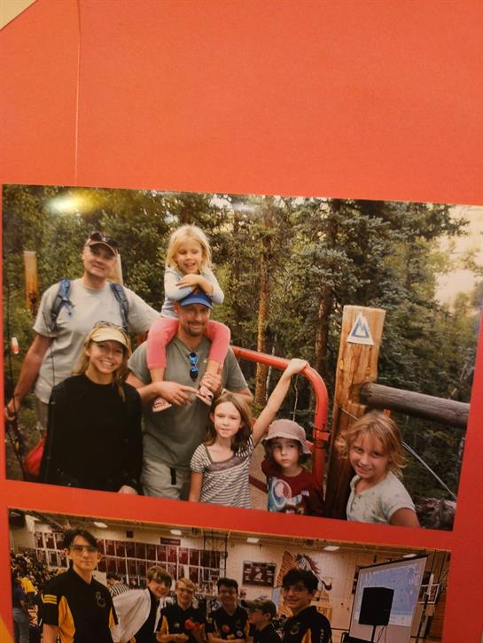 Group of people smiles together in a forested area, creating lasting memories during a hike.