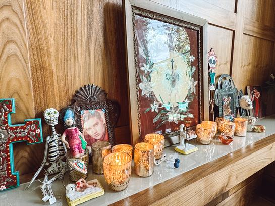 This vibrant altar showcases candles and skeletons honoring the Day of the Dead.