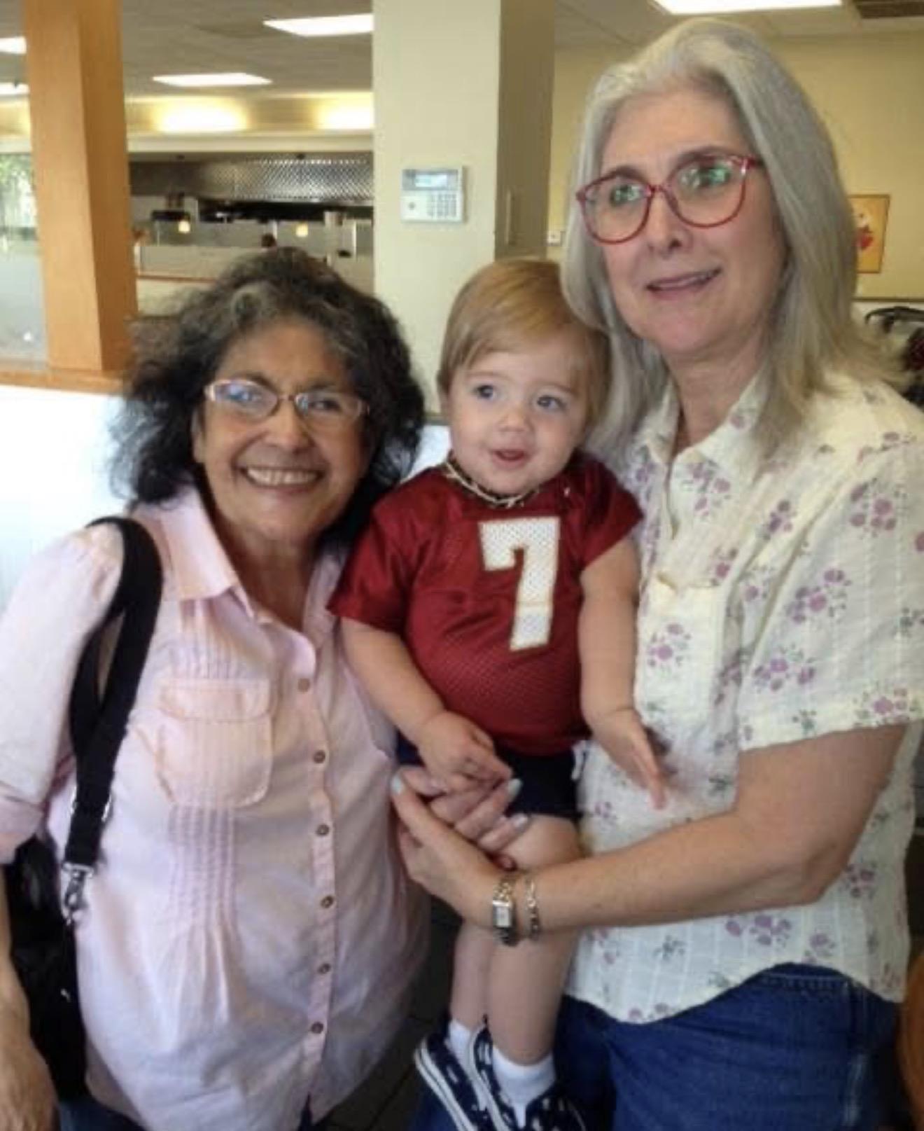 A group of women holding a baby