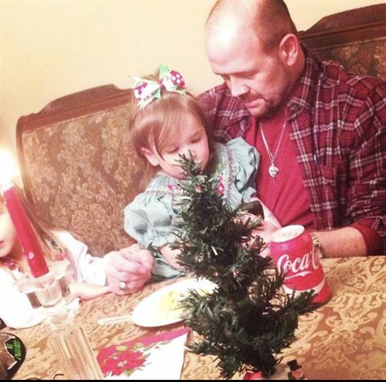 Children and adult enjoy time together with food and decorations at a festive celebration.
