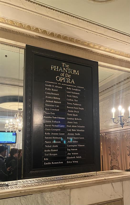 A display honoring the cast of The Phantom of the Opera during a theater event.