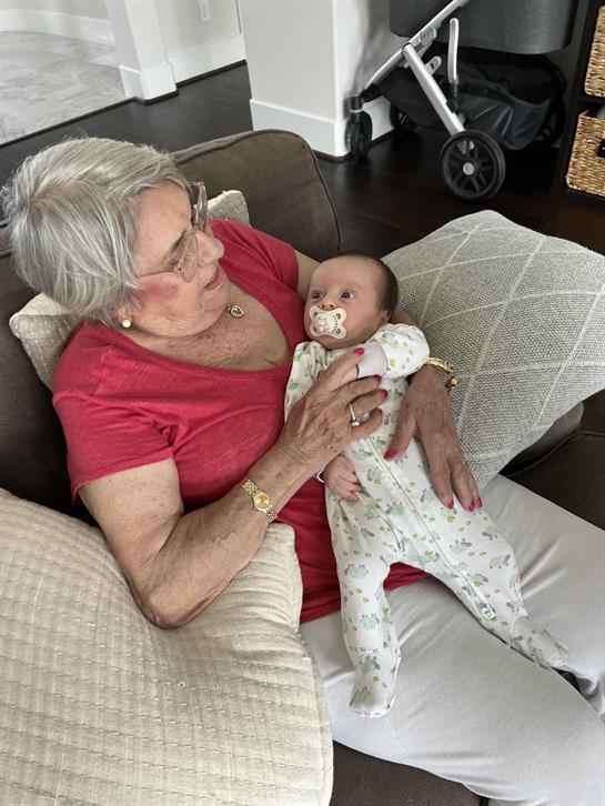 An old woman holding a baby