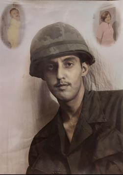 A soldier in uniform confidently gazes at the camera, memories reflected in his eyes.