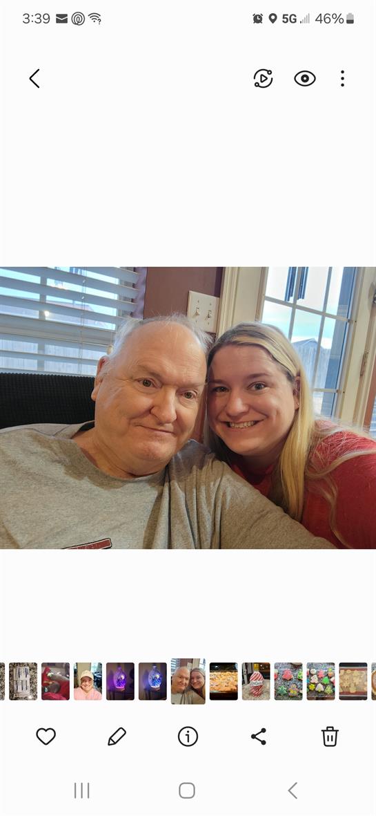 A joyful moment shared between a man and woman in a warmly lit living room.