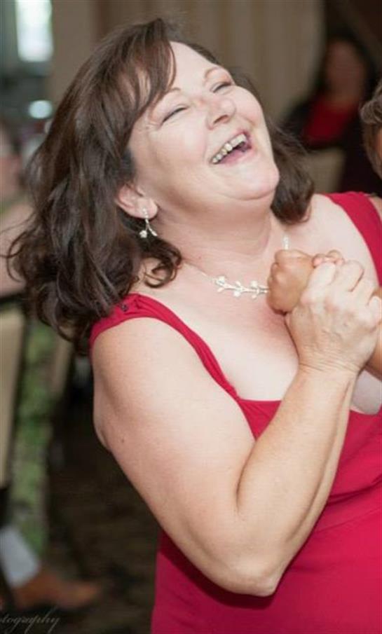 A joyful woman revels in the celebration, connecting with others in the lively atmosphere.