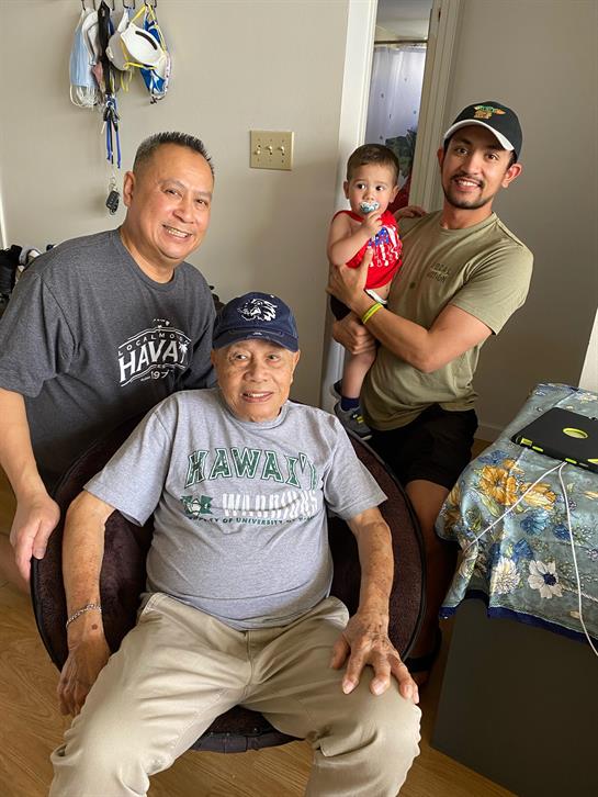 Family members enjoy a warm moment together in a living room, showcasing generational bonds.