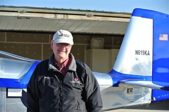 A man standing in front of a plane
