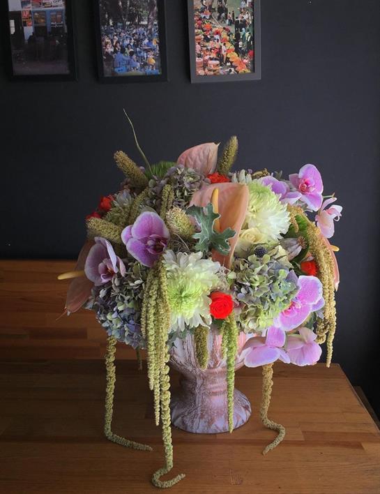 A stunning floral arrangement with various blooms and greenery adds elegance to the gathering space.