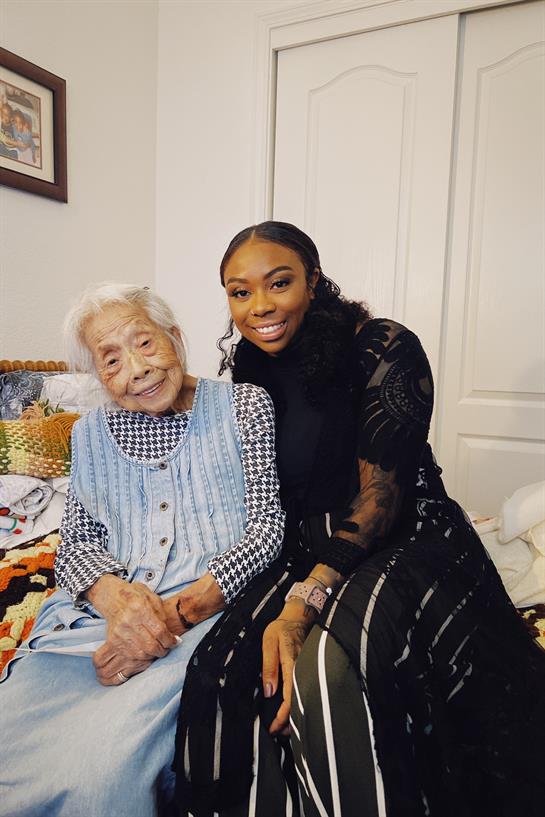 Granddaughter spends quality time with grandmother while discussing beauty tips at home.