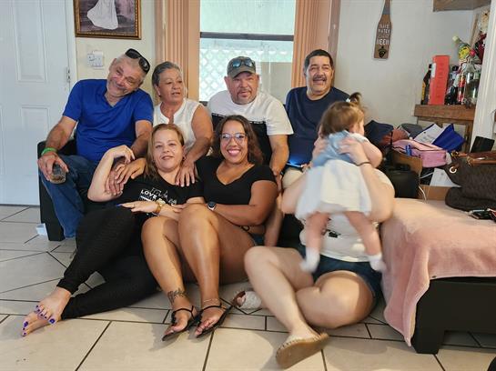 A joyful family gathering is taking place indoors, showcasing love and togetherness.