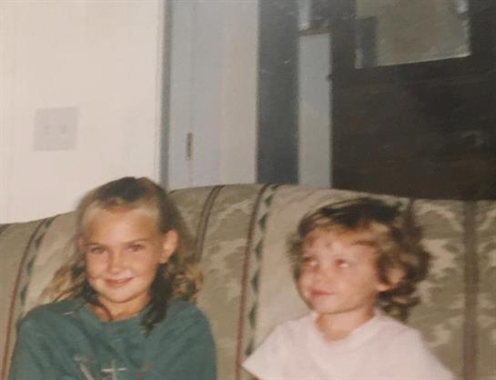 A couple of children sitting on a couch